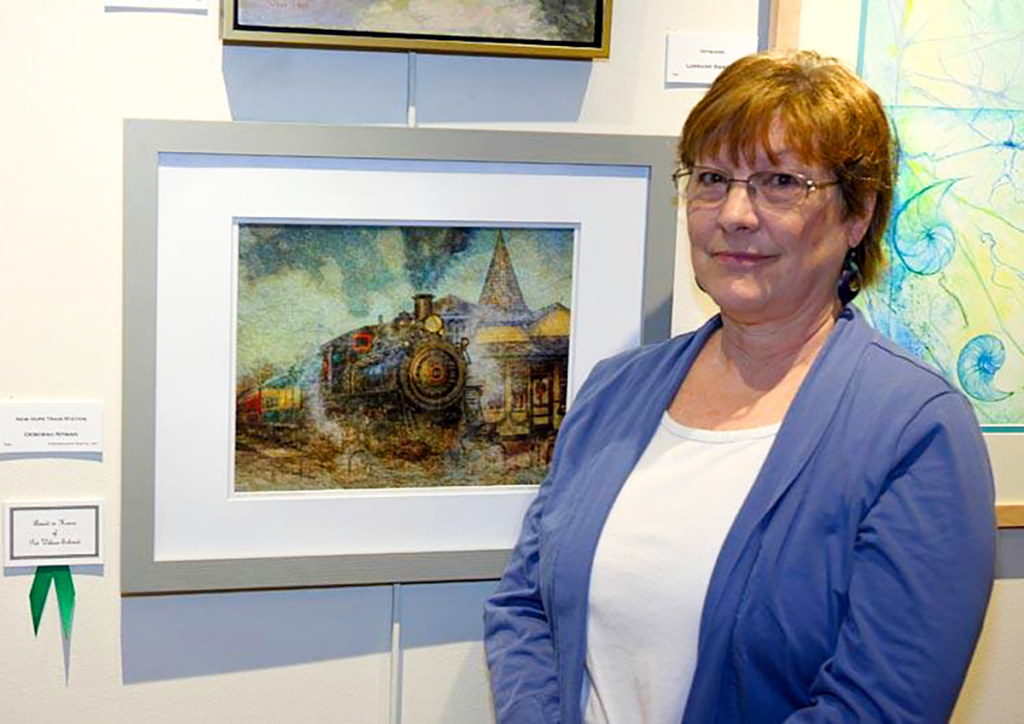 Deborah Nyman, artist next to her photography work